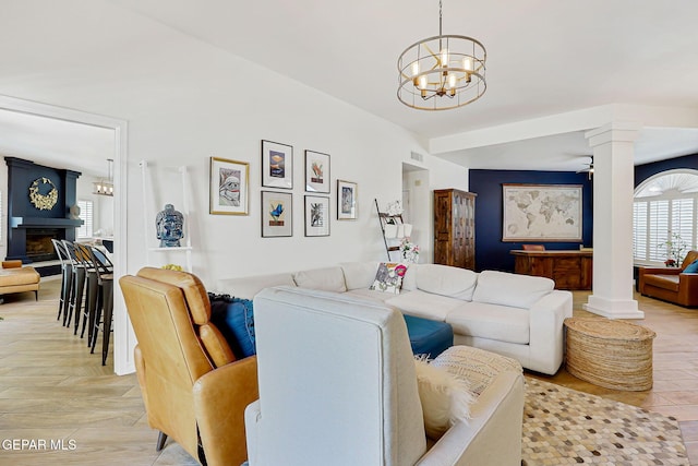 904 Las Palmas Way, El Paso, TX 79912 - living room featuring decorative columns, a chandelier, and a fireplace with raised hearth