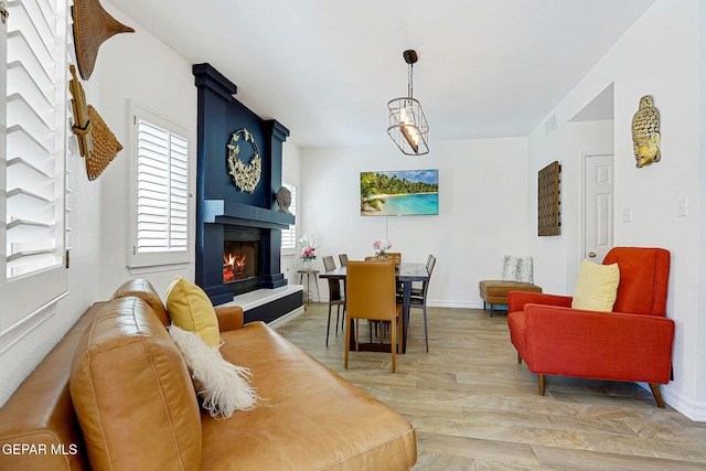 904 Las Palmas Way, El Paso, TX 79912 - living area featuring light wood finished floors, a fireplace, and baseboards