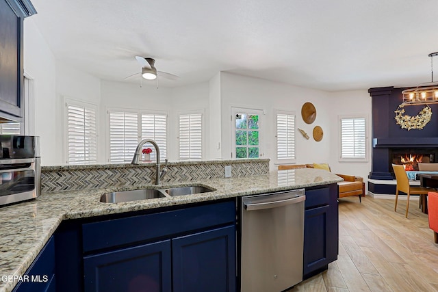 904 Las Palmas Way, El Paso, TX 79912 - kitchen featuring stainless steel dishwasher, a sink, blue cabinetry, ceiling fan, and open floor plan