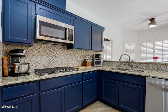 904 Las Palmas Way, El Paso, TX 79912 - kitchen with stainless steel appliances, blue cabinetry, a sink, and tasteful backsplash