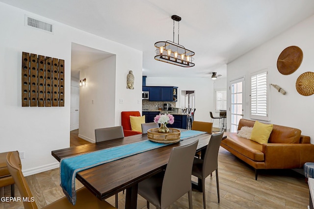 904 Las Palmas Way, El Paso, TX 79912 - dining space featuring a chandelier, ceiling fan, baseboards, and light wood-style flooring