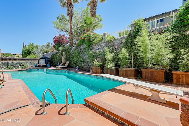 904 Las Palmas Way, El Paso, TX 79912 - view of swimming pool featuring a diving board, a fenced backyard, and a patio