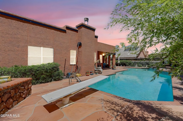 904 Las Palmas Way, El Paso, TX 79912 - pool at dusk featuring a patio and a diving board