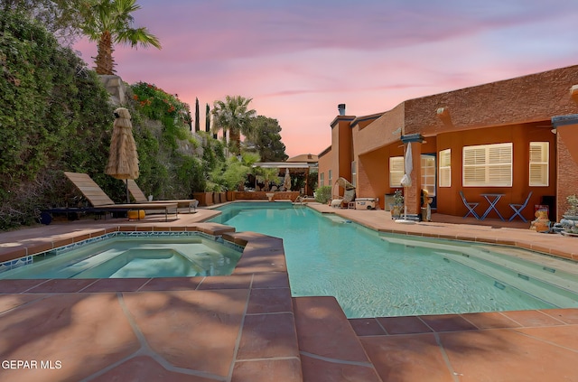 904 Las Palmas Way, El Paso, TX 79912 - pool at dusk with an outdoor pool, an in-ground hot tub, and a patio