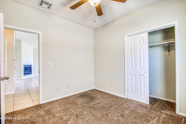 11361 Charles Reynolds Ln, El Paso, TX 79934 - unfurnished bedroom with carpet, baseboards, a closet, a textured ceiling, and ceiling fan