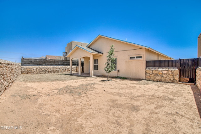 11361 Charles Reynolds Ln, El Paso, TX 79934 - rear view of house with a fenced backyard, a gate, and stucco siding