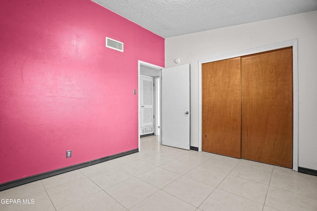 9913 Bomarc St, El Paso, TX 79924 - unfurnished bedroom featuring a closet, a textured ceiling, and baseboards