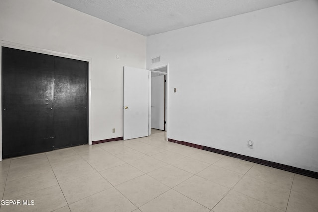 9913 Bomarc St, El Paso, TX 79924 - unfurnished bedroom featuring baseboards, vaulted ceiling, and a textured ceiling
