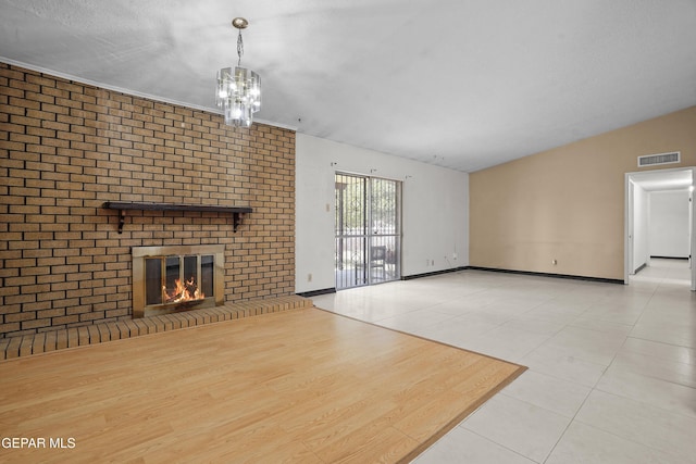9913 Bomarc St, El Paso, TX 79924 - unfurnished living room featuring tile patterned flooring, a fireplace, a chandelier, and baseboards