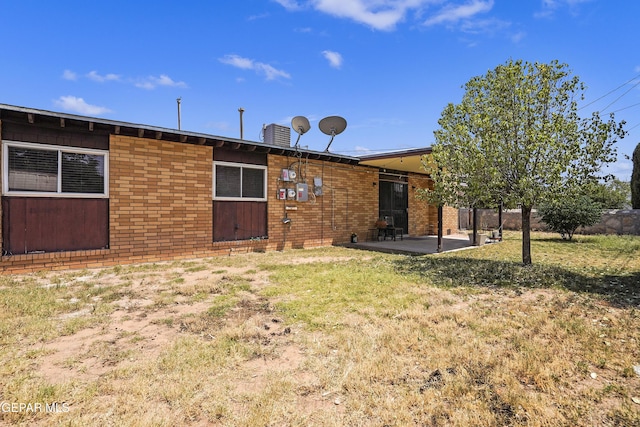9913 Bomarc St, El Paso, TX 79924 - rear view of house featuring a patio, brick siding, and a yard