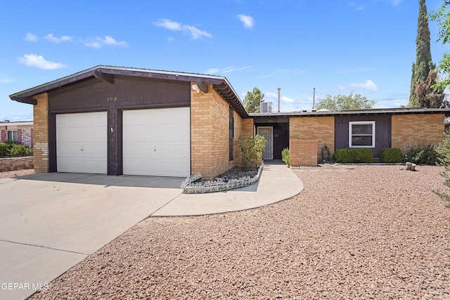 9913 Bomarc St, El Paso, TX 79924 - view of front of house featuring brick siding, driveway, and a garage