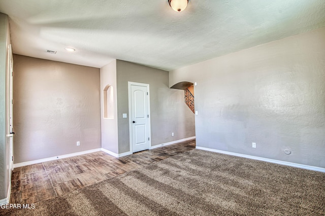 12772 Silver Streak Ave, El Paso, TX 79928 - unfurnished room featuring baseboards, wood finished floors, and arched walkways