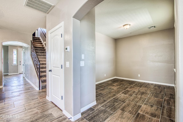 12772 Silver Streak Ave, El Paso, TX 79928 - foyer featuring arched walkways, wood finish floors, and baseboards
