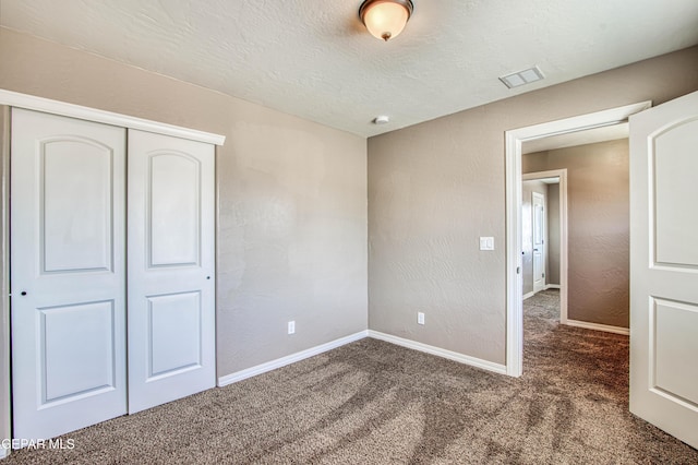 12772 Silver Streak Ave, El Paso, TX 79928 - unfurnished bedroom featuring carpet flooring, a closet, baseboards, and a textured ceiling