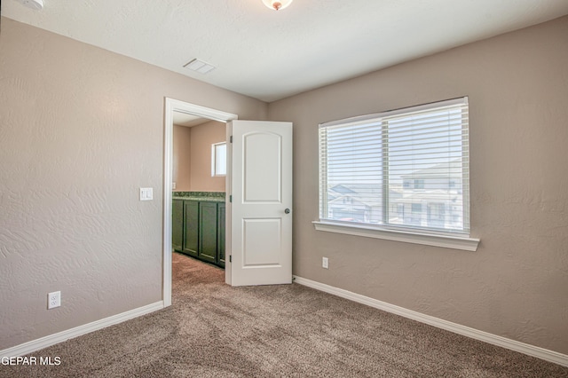 12772 Silver Streak Ave, El Paso, TX 79928 - carpeted empty room featuring baseboards and a textured wall
