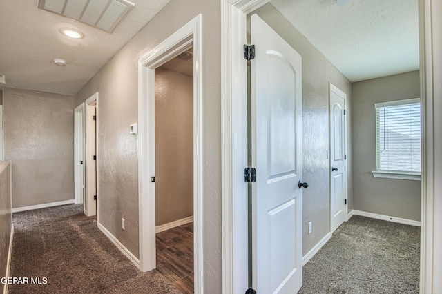 12772 Silver Streak Ave, El Paso, TX 79928 - hallway featuring baseboards, carpet, and a textured ceiling