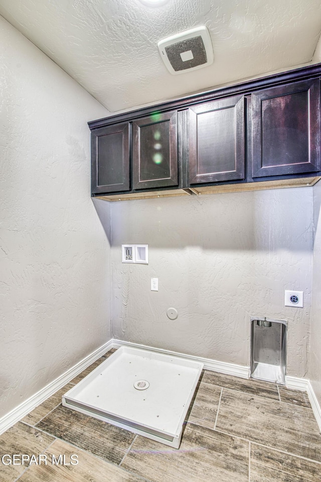 12772 Silver Streak Ave, El Paso, TX 79928 - laundry room with washer hookup, electric dryer hookup, wood finished floors, baseboards, and cabinet space