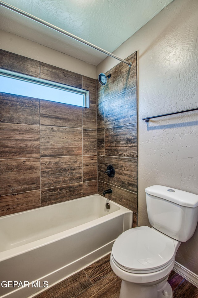 12772 Silver Streak Ave, El Paso, TX 79928 - full bath with wood finished floors, toilet, bathtub / shower combination, a textured ceiling, and baseboards