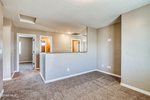 12772 Silver Streak Ave, El Paso, TX 79928 - carpeted empty room featuring attic access and baseboards