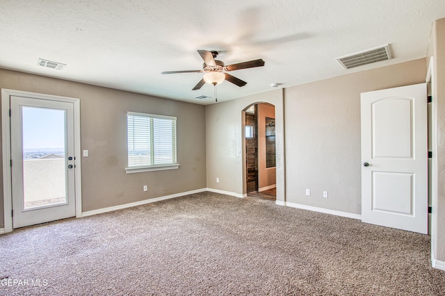 12772 Silver Streak Ave, El Paso, TX 79928 - unfurnished bedroom with arched walkways, carpet flooring, and baseboards