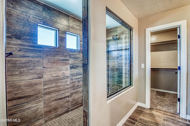 12772 Silver Streak Ave, El Paso, TX 79928 - full bath featuring a shower stall, a walk in closet, and baseboards