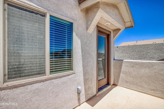 12772 Silver Streak Ave, El Paso, TX 79928 - view of exterior entry featuring stucco siding and a balcony