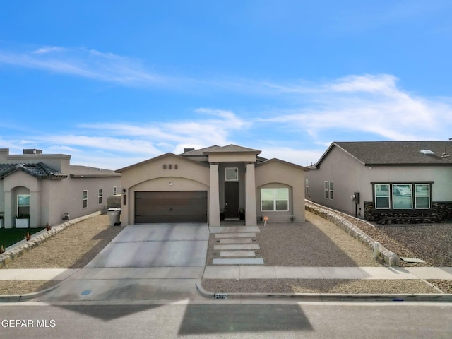 2367 Enchanted Peaks Ln, El Paso, TX 79911 - view of front of property with stucco siding, driveway, and a garage