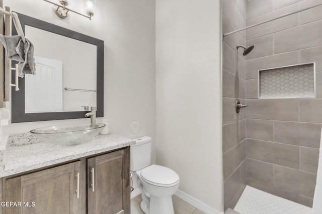 2367 Enchanted Peaks Ln, El Paso, TX 79911 - bathroom featuring tiled shower, toilet, vanity, and tile patterned floors