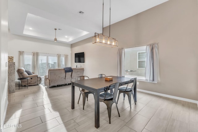 2367 Enchanted Peaks Ln, El Paso, TX 79911 - dining room featuring a tray ceiling, baseboards, and a chandelier