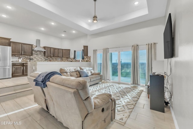 2367 Enchanted Peaks Ln, El Paso, TX 79911 - living area featuring recessed lighting, a towering ceiling, and a tray ceiling