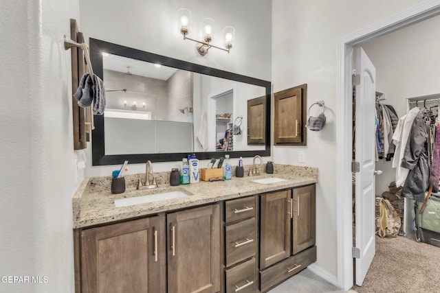2367 Enchanted Peaks Ln, El Paso, TX 79911 - bathroom with a walk in closet, double vanity, and tiled shower