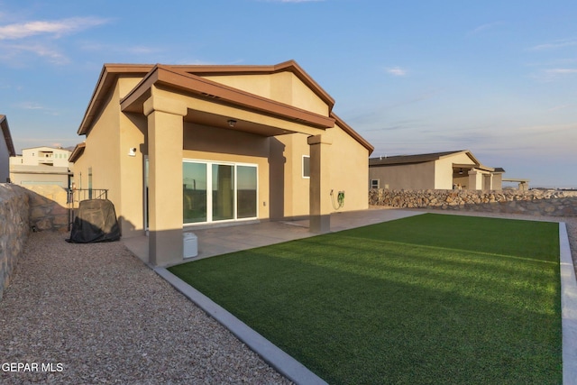 2367 Enchanted Peaks Ln, El Paso, TX 79911 - back of house with stucco siding and a patio area