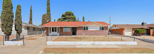 10321 Thor St, El Paso, TX 79924 - view of front of house featuring brick siding, concrete driveway, and a fenced front yard