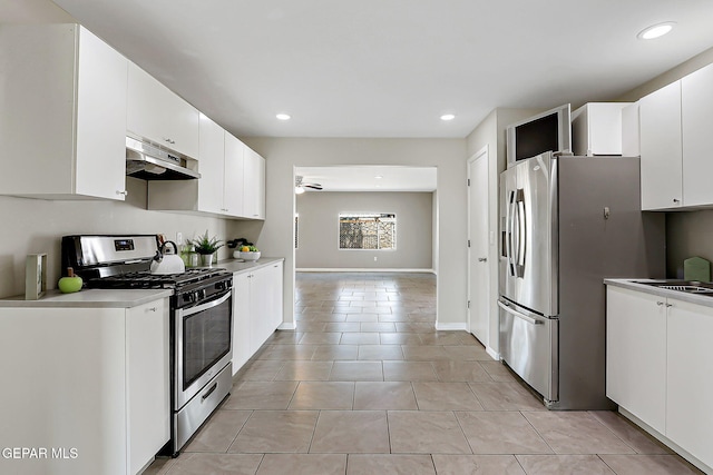 10321 Thor St, El Paso, TX 79924 - kitchen with under cabinet range hood, stainless steel appliances, recessed lighting, white cabinetry, and light tile patterned floors