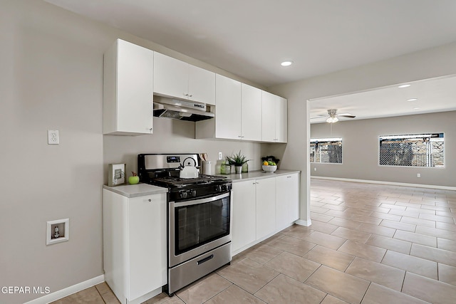10321 Thor St, El Paso, TX 79924 - kitchen with under cabinet range hood, gas range, ceiling fan, light countertops, and white cabinets