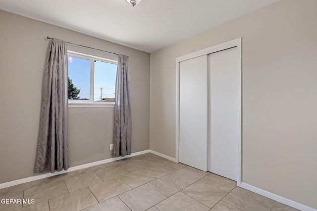 10321 Thor St, El Paso, TX 79924 - unfurnished bedroom with a closet, baseboards, and light tile patterned flooring