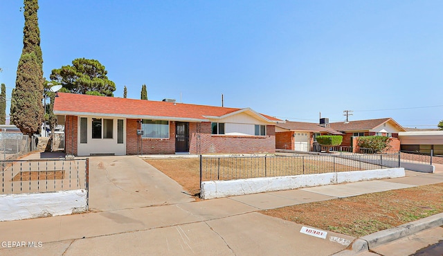 10321 Thor St, El Paso, TX 79924 - ranch-style home featuring brick siding, a fenced front yard, and roof with shingles