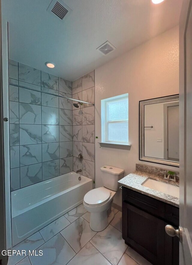 12868 Star Gaze Ave, El Paso, TX 79928 - full bath featuring vanity, bathing tub / shower combination, toilet, marble look tile flooring, and baseboards
