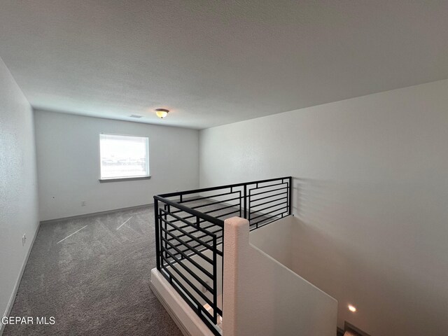 12868 Star Gaze Ave, El Paso, TX 79928 - hallway with an upstairs landing, carpet floors, and baseboards