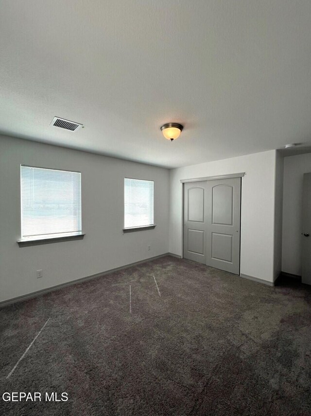 12868 Star Gaze Ave, El Paso, TX 79928 - unfurnished bedroom with carpet flooring, baseboards, and a closet