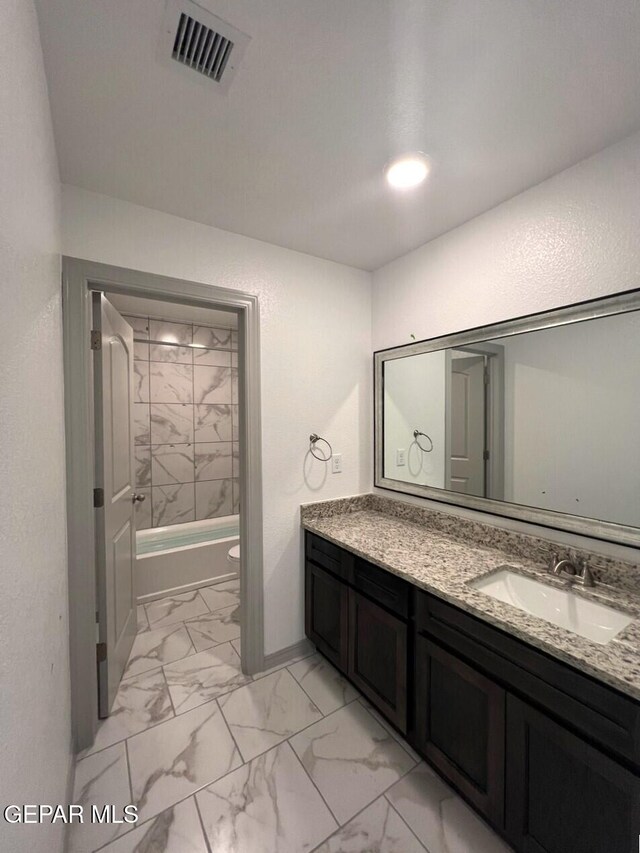 12868 Star Gaze Ave, El Paso, TX 79928 - bathroom with vanity, toilet, marble look tile flooring, shower / washtub combination, and baseboards