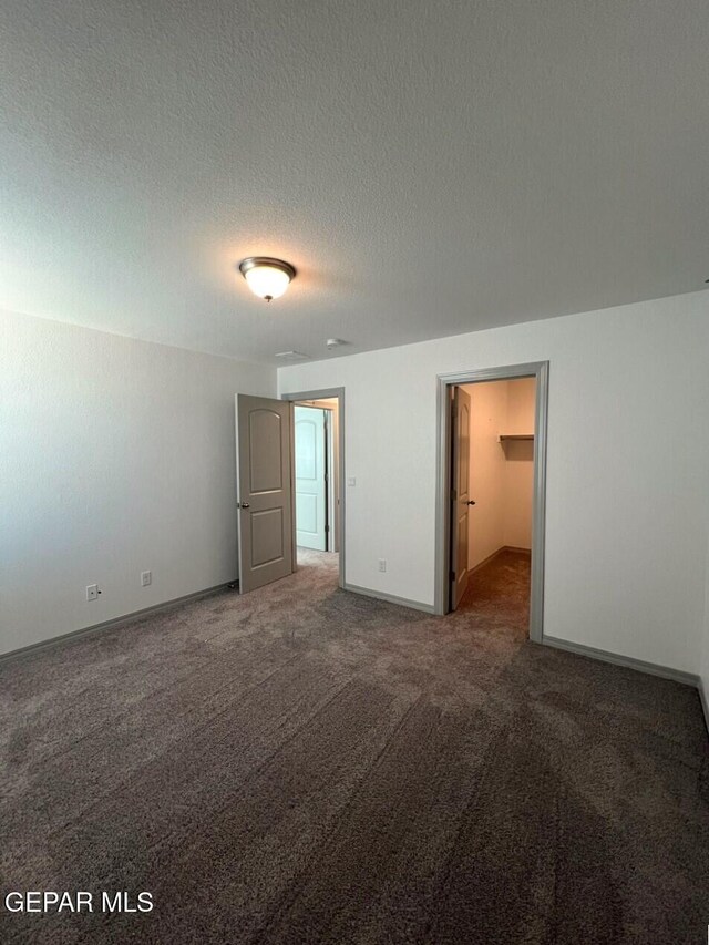 12868 Star Gaze Ave, El Paso, TX 79928 - unfurnished room featuring carpet, baseboards, and a textured ceiling