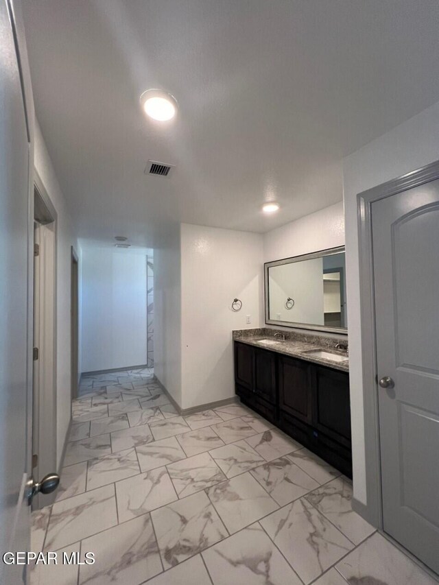 12868 Star Gaze Ave, El Paso, TX 79928 - full bath with marble finish flooring, double vanity, and baseboards