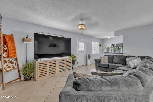 5717 Port Lavaca Dr, El Paso, TX 79924 - living room featuring light tile patterned flooring, baseboards, and a textured ceiling