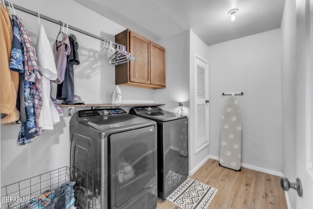 5717 Port Lavaca Dr, El Paso, TX 79924 - laundry room featuring independent washer and dryer, cabinet space, light wood-style flooring, and baseboards