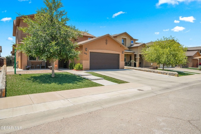 14382 Karen Point Ct, El Paso, TX 79938 - view of front of house with stucco siding, a garage, concrete driveway, and a front yard