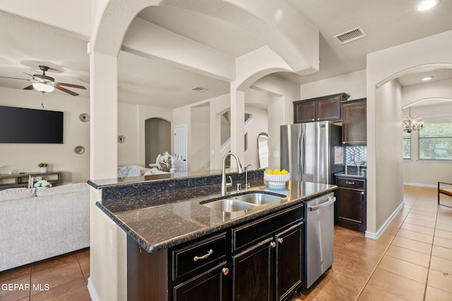 14382 Karen Point Ct, El Paso, TX 79938 - kitchen featuring a sink, arched walkways, appliances with stainless steel finishes, open floor plan, and recessed lighting