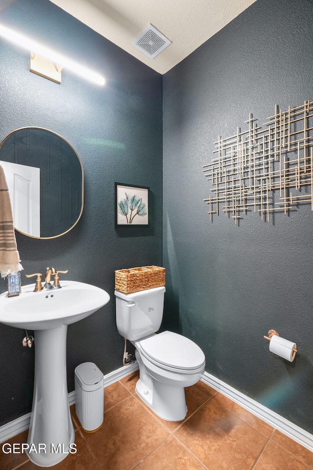 14382 Karen Point Ct, El Paso, TX 79938 - bathroom with toilet, tile patterned floors, baseboards, and a sink