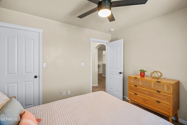 14382 Karen Point Ct, El Paso, TX 79938 - bedroom with arched walkways, baseboards, carpet flooring, and ceiling fan