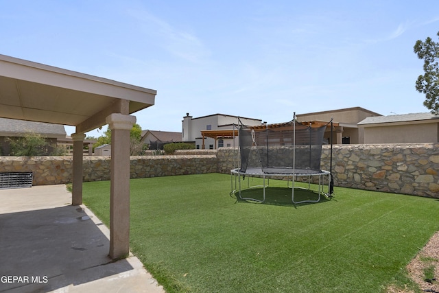 1497 Dunlin Pl, El Paso, TX 79928 - fenced backyard with a trampoline and a patio area